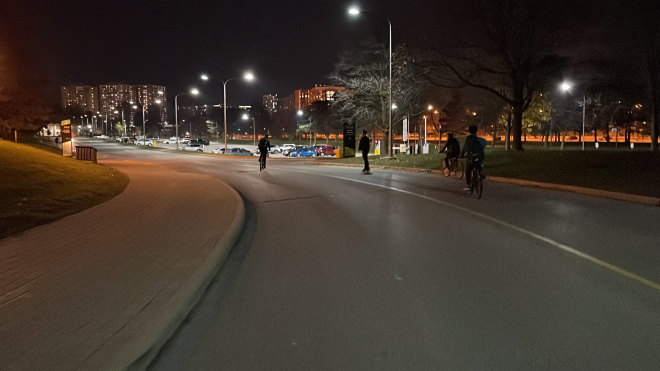 People biking at night at Waterloo outside.